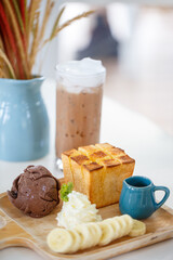 Delicious dessert with chocolate ice cream, whipped cream, and banana