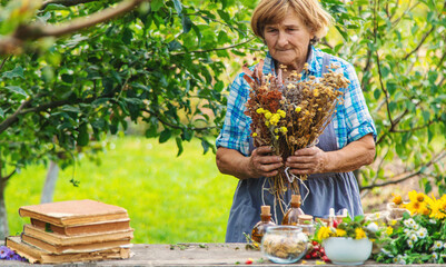 Medicinal herbs alternative medicine old woman. Selective focus.