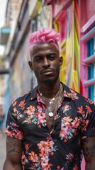 Obraz premium Young man with bright pink hair and tattoos on background of colored buildings. Great for fashion blogs, clothing ads and social media.