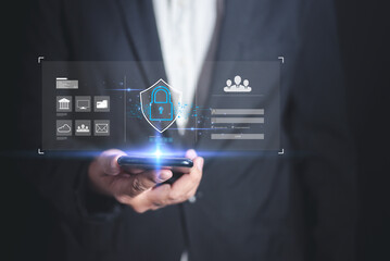 Fototapeta premium A professional individual holding a smartphone with digital security icons and data overlays, emphasizing technology and security.