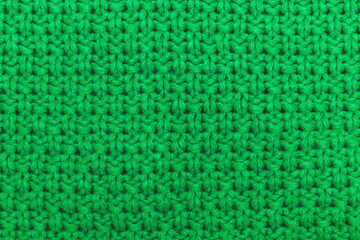 Close-up of vibrant green crochet texture showcasing tight, uniform stitches in a repetitive...