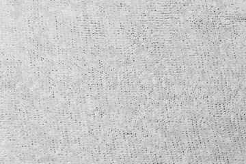 Close-up of a soft, textured, white fabric featuring a looped pattern.