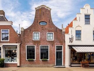 Historic brick house with clock gable in old town of Makkum, Friesland, Netherlands