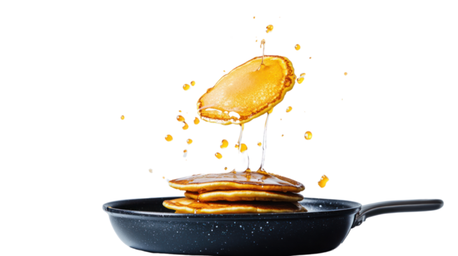Delicious pancakes flipping in a frying pan, drizzled with golden syrup, capturing the essence of a perfect breakfast treat.
