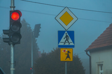 road during morning fog. Bad weather conditions while driving will occur in autumn and winter. poor...