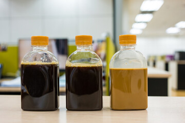 A one bottle of ice black coffee and two coffee latte bottles. Refreshing cold beverage a crisp and...