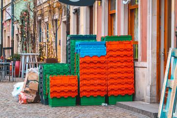 plastic boxes in front of the store after the delivery of food. garbage and cardboard boxes lying outside the store.