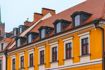 church buildings, church towers, interesting old historical architecture in the city with unique decorations. windows in the roof of the building. renovated old building.