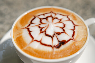 Top view of a cup of fresh aromatic morning coffee on a marble table.