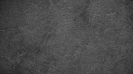 A black and white photo of a wall with a lot of texture. The photo is grainy and has a lot of detail