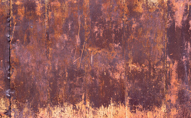 Old rusty metal wall with cracked paint