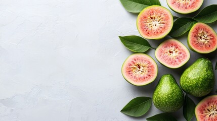 Isolated of guavas with leaves attached scattered naturally across a white background for a fresh appearance Stock Photo with side copy space