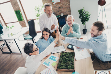 Photo high view of teamwork people working together highfive support comfortable modern office loft room interior indoors workspace