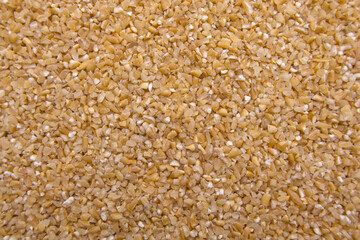 Full-Frame Close-Up of Broken Wheat (Dalia) - Cracked Wheat Texture Macro