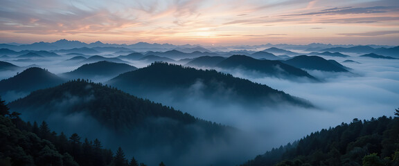 Obraz premium A breathtaking serene mountain range covered in mist during dawn, showcasing the tranquility and pristine nature of the landscape with soft light and shadows. Wide Background