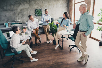Full body photo of teamwork people working together brainstorming comfortable modern office loft...