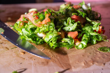 Mixing lettuce and tomato