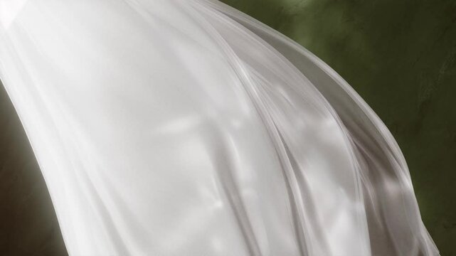 Ethereal light fabric curtain flowing against a textured dark green surface. Beauty, fashion and lifestyle dreamy delicate feel looping animation backdrop