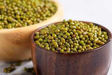 Dried mung beans in a rustic bowl. Healthy plant-based protein, healthy cooking ingredient for vegan recipes and vegetarian diets, close up
