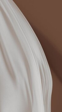 Curtain of sheer, flowing fabric with delicate curves and folds. Soft creamy tone elegant composition aesthetic background