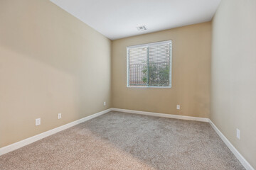Spacious living room with wooden flooring and sliding doors leading to a bright outdoor area