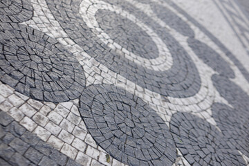 Cobblestone mosaic creating circular patterns on prague pavement