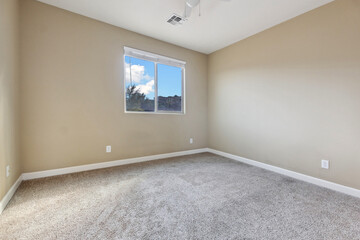 Spacious living room with wooden flooring and sliding doors leading to a bright outdoor area