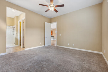 Spacious living room with wooden flooring and sliding doors leading to a bright outdoor area
