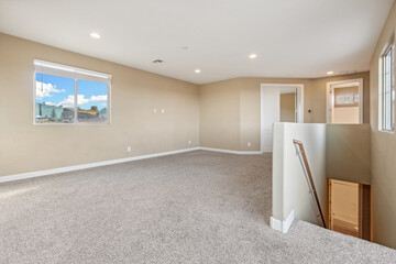 Spacious living room with wooden flooring and sliding doors leading to a bright outdoor area