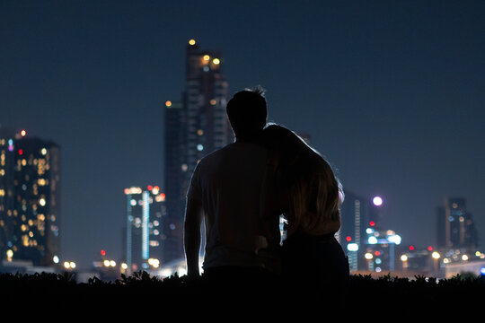 a couple in the city at night