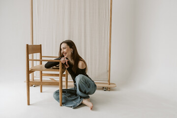 Attractive young caucasian woman wearing blue jeans sitting on the floor