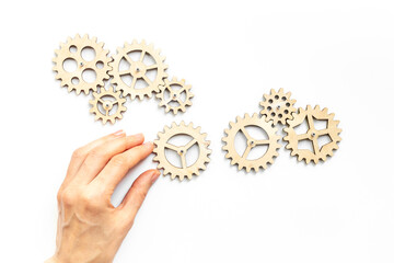 Hand holding a chain of gears cogwheels. Business process and automation concept