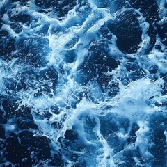 Fototapeta premium Deep blue ocean waves crash and churn creating a dramatic seascape. Perfect for backgrounds, website banners, or art prints that evoke the power of nature.