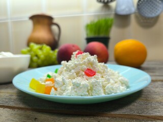 Homemade rustic crumbly cottage cheese on a plate. Still-life. High quality photo