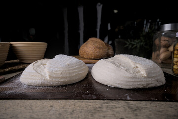 Raw Fresh artisan bread dough ready to bake on a Rustic Wooden Table.