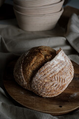Artisan Batard Sourdough healthy Bread. Open crumb high hydration Sourdough french country bread set on dark background.
