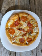 Delicious meat pizza on a white plate.