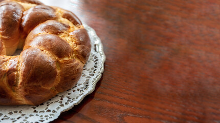 Easter bread, greek tsoureki braid on table, top view