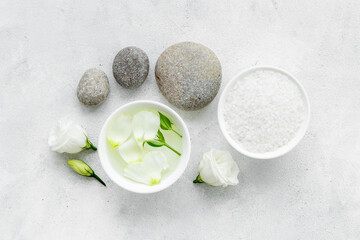 Blank white bottles of skin care cosmetics with roses