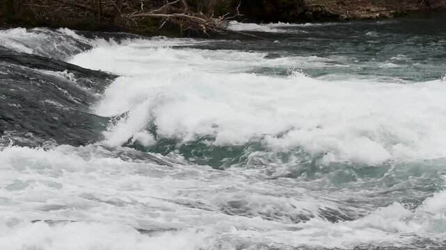 Cascade on rapid mountain stream, splashing turbulent water on river Una in National Park Una