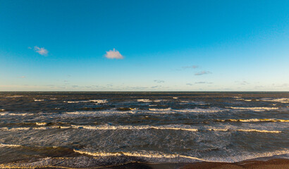 Sea in sunny weather with blue sky. Waves. Sea background
