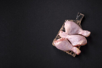 Raw chicken legs with salt, spices and herbs