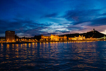 Fototapeta premium Budapest at night. View of the University of Technology and Economics. Nighttime view from the river side. Lights reflect on the Danube. Hungary, Europe.