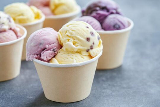 A group of colorful ice cream cups arranged on a table, perfect for a party or outdoor event