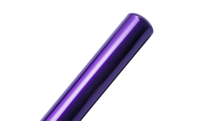 A close-up image showcases a glossy deep purple cylindrical object against a stark black backdrop.