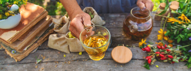 Medicinal herbs and tea old woman. Selective focus.