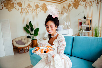 Elegant young woman in vintage dress holding a sushi platter, merging historical charm with modern...