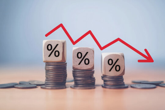 Percentage sign on wooden cubes with Stack of coin bar chart and red graph trending downwards on white background. Economy recession crisis, inflation, stagflation, business and financial loss concept