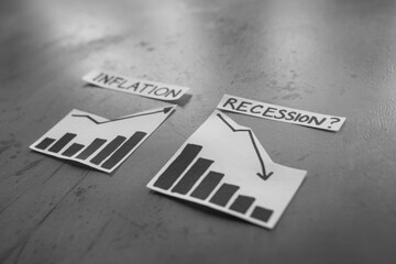 Fototapeta premium inflation and recession texts and graphs showing prices going up and growth going down 