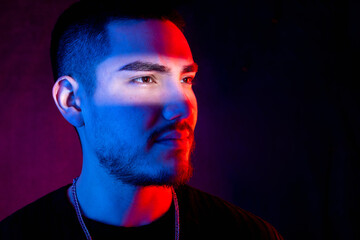 Serious man in a creative light pattern, blending red and blue tones, showcasing a friendly and modern vibe, S trip of white light illuminates his eyes.